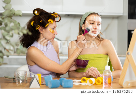 Applying mask to woman's face with brush 126375293