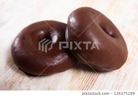 Two chocolate glazed donuts Two chocolate glazed donuts 126375299