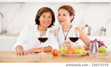 Party for girlfriends - women drinking wine and telling each other news 126375378