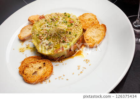 Salmon tartare with guacamole and toasted bread Salmon tartare with guacamole and toasted bread 126375434