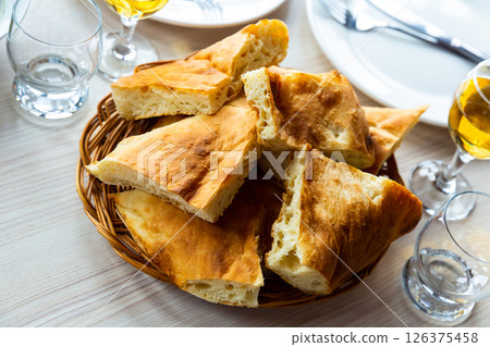 Slices of traditional Georgian bread shotis puri on dining table Slices of traditional Georgian bread shotis puri on dining table 126375458