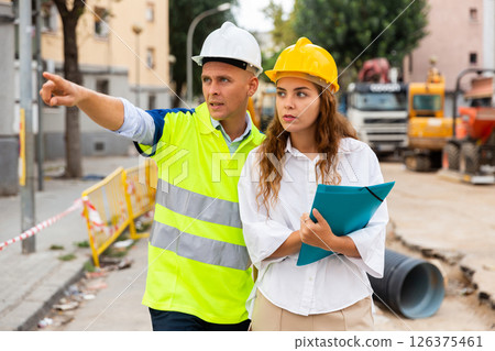 Master builder and architect talking in construction area Master builder and architect talking in construction area 126375461