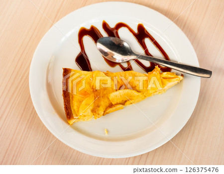 Apple cheesecake slice with shortcrust pasty on plate with balsamic glaze Apple cheesecake slice with shortcrust pasty on plate with balsamic glaze 126375476