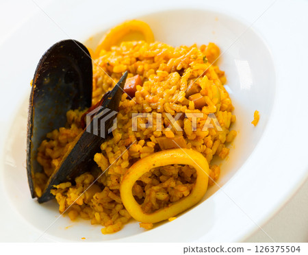Tasty seafood dish - Paella a la marinera Tasty seafood dish - Paella a la marinera 126375504