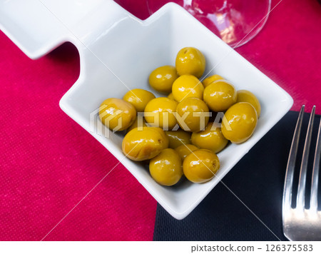 Pickled olives with a stone - a typical Spanish tapas. Pickled olives with a stone - a typical Spanish tapas. 126375583