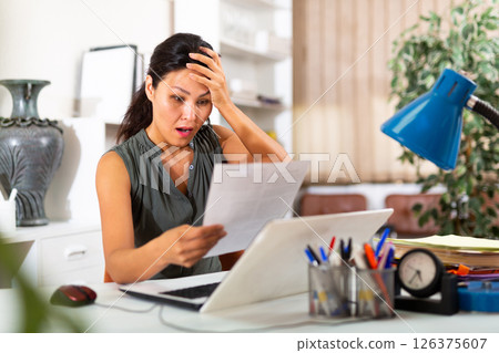 Tired businesswoman working with documents in office 126375607