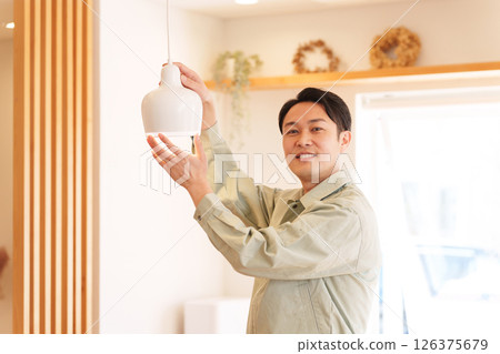 Contractor installing light bulbs 126375679