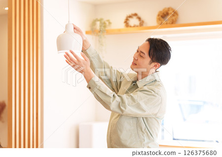 Contractor installing light bulbs 126375680