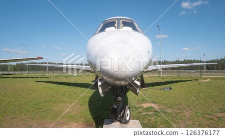 A vintage Soviet aircraft is prominently displayed outdoors, highlighting its sleek design and mechanical features against a clear blue sky in Russias landscape. A vintage Soviet aircraft is prominently displayed outdoors, highlighting its sleek design and mechanical features against a clear blue sky in Russias landscape. 126376177