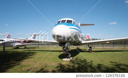 A vintage airplane from the USSR era sits on display in a grassy area in Russia, highlighting the history of aviation and the engineering of the time. 126376188