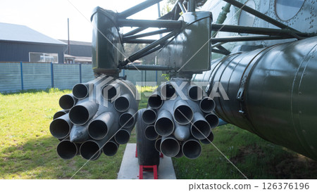 Rocket pods of a military helicopter are showcased outdoors, emphasizing the vintage Soviet engineering from the USSR era, with detailed craftsmanship on display. Rocket pods of a military helicopter are showcased outdoors, emphasizing the vintage Soviet engineering from the USSR era, with detailed craftsmanship on display. 126376196