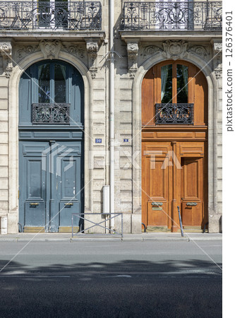 Architectural splendour details of wooden front doors with glass windows and wrought iron steel balcony. 126376401