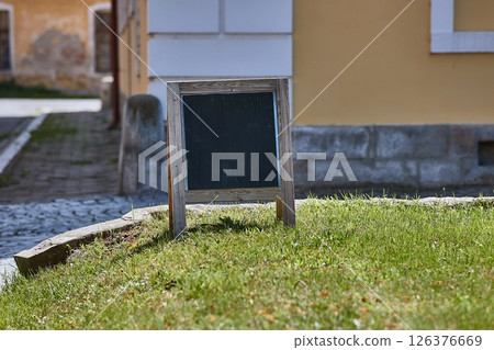 Signboard for a cafe showing direction on the street 126376669