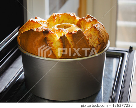 The faint aroma of freshly baked happiness. The moment of making a homemade chiffon cake The faint aroma of freshly baked happiness. The moment of making a homemade chiffon cake 126377223