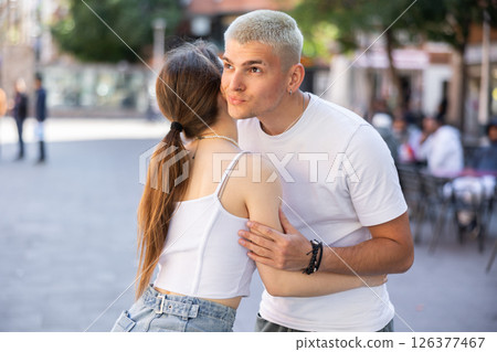 Friends met after long separation, greet and hug Friends met after long separation, greet and hug 126377467