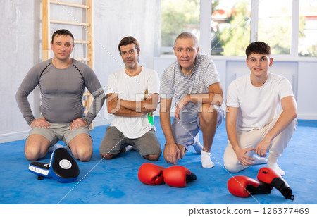 Portrait of athletic men of different ages after boxing training in gym Portrait of athletic men of different ages after boxing training in gym 126377469