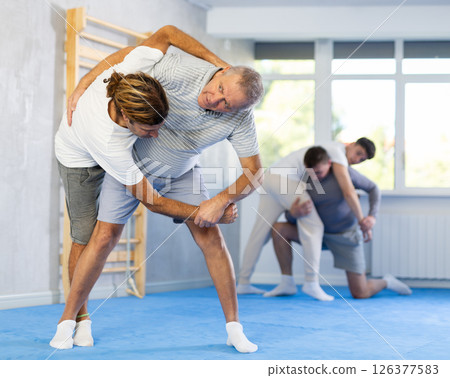 Adult and elderly men training judo fight Adult and elderly men training judo fight 126377583