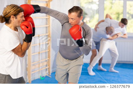 Two men training boxing fight in studio 126377679