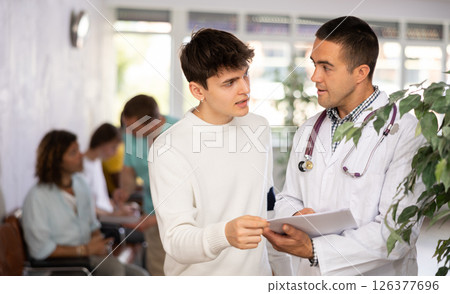 Doctor consults a man at the clinic Doctor consults a man at the clinic 126377696