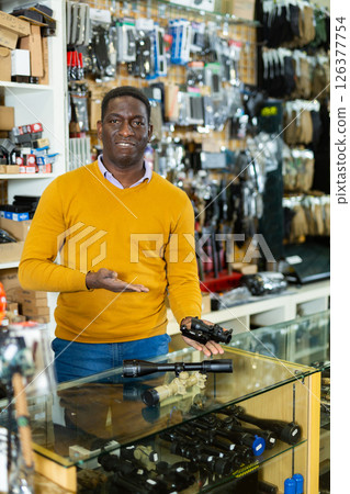 African american gunsmith demonstrating rifle scope for sale African american gunsmith demonstrating rifle scope for sale 126377754