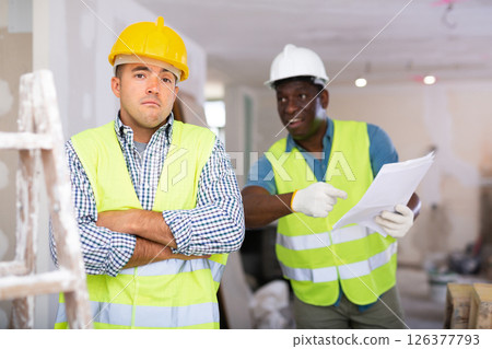 Portrait of confused man builder and angry foreman in construction site 126377793