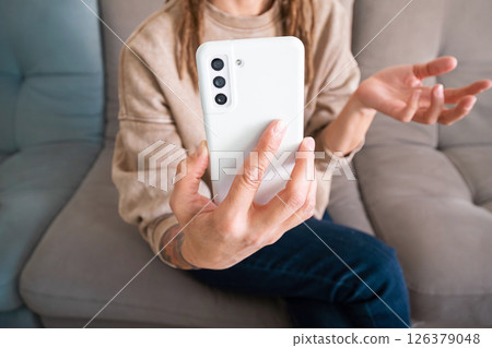 Woman Holding Mobile Phone for Video Call. Female Using Smartphone Application for Virtual Communication. Woman Holding Mobile Phone for Video Call. Female Using Smartphone Application for Virtual Communication. 126379048