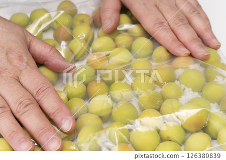 Steps for making crispy plums using small plums Put pre-processed small plums and salt in a ziplock bag and roll with your hands. 126380839