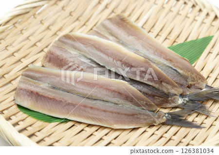 Opened sardines in a basket on a white background Opened sardines in a basket on a white background 126381034