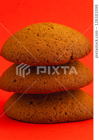 Delicious ginger cookies stacked against a vibrant background 126381098