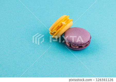 Colorful macarons on a blue background showcase pastry delight Colorful macarons on a blue background showcase pastry delight 126381126