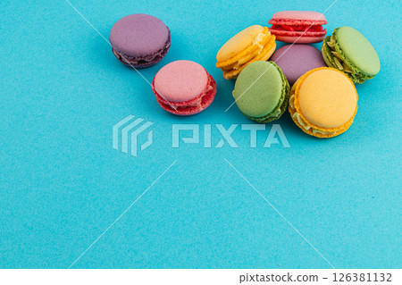 Colorful macarons arranged on a blue background 126381132