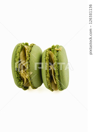 Delightful green macarons with creamy filling shown together 126381136