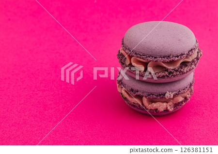 Delicious purple macarons on vibrant background 126381151