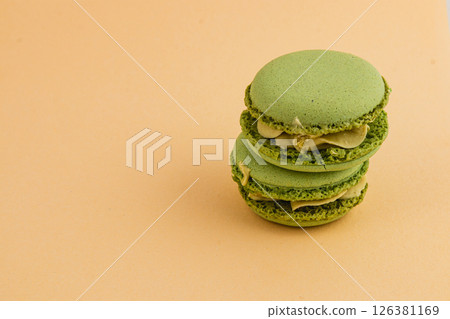 Delicious green macarons stacked on a simple background Delicious green macarons stacked on a simple background 126381169