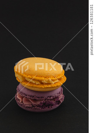 Colorful macarons stacked on a black background 126381181