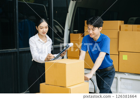 Express Delivery Service. Asian Courier Delivering Package to man Delivery service near van outside the warehouse, delivery home 126381664