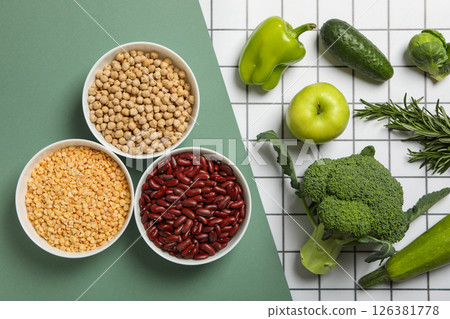 Set of vegetarian protein products on green and white background, top view 126381778