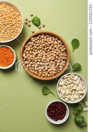 Beans in bowls on green background, top view Beans in bowls on green background, top view 126381783