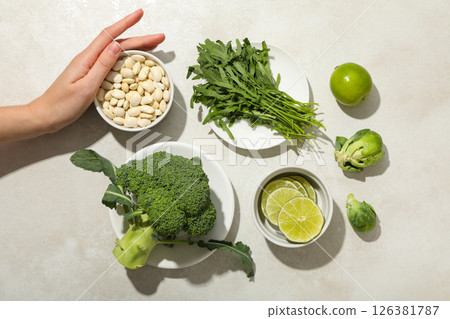 Set of vegan protein products on bowl and plate, female hand on light background, top view Set of vegan protein products on bowl and plate, female hand on light background, top view 126381787