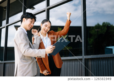 Businessman and woman going in city center in smart casual business style, talking, working together, stylish freelance people, holding coffee 126381949
