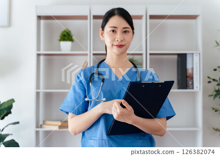 Asian female doctor or nurse standing confidently with stethoscope hanging on her neck in office Asian female doctor or nurse standing confidently with stethoscope hanging on her neck in office 126382074