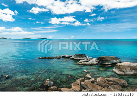Tropical beach and sea with fresh summer sky on Koh Samui. Beach chairs and umbrellas. Seaside vacation. Summer getaway. 126382116
