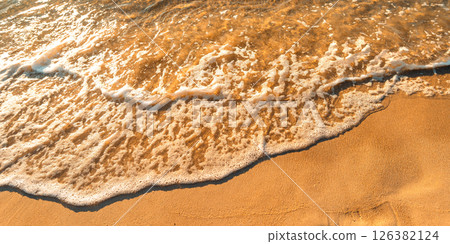 Sand on the beach and sea waves in the morning, orange tone. Sand on the beach and sea waves in the morning, orange tone. 126382124