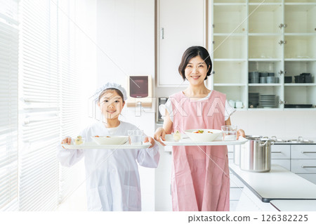 Girls and women wearing white coats carrying meals 126382225