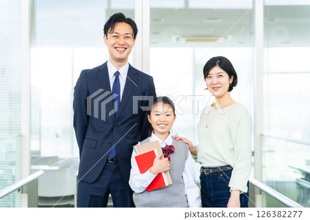 Mother and teacher support elementary school girl 126382277