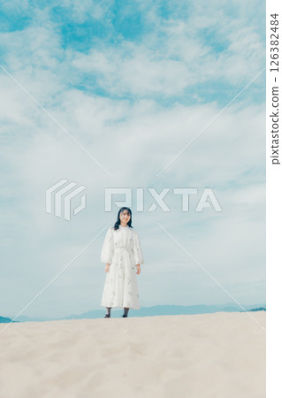 A portrait of a woman with a sense of clarity, surrounded by blue skies and the sea 126382484