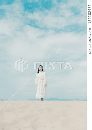 A portrait of a woman with a sense of clarity, surrounded by blue skies and the sea A portrait of a woman with a sense of clarity, surrounded by blue skies and the sea 126382485