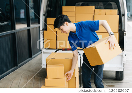 Asian courier delivery man searching the address on digital tablet.  near van outside the warehouse. This is a freight transportation 126382607