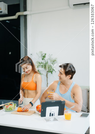 Fitness duo celebrating healthy living with fresh salad, fruits, and juice. A perfect balance of wellness, nutrition Fitness duo celebrating healthy living with fresh salad, fruits, and juice. A perfect balance of wellness, nutrition 126383067