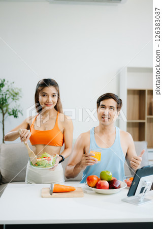 Fitness duo celebrating healthy living with fresh salad, fruits, and juice. A perfect balance of wellness, nutrition Fitness duo celebrating healthy living with fresh salad, fruits, and juice. A perfect balance of wellness, nutrition 126383087